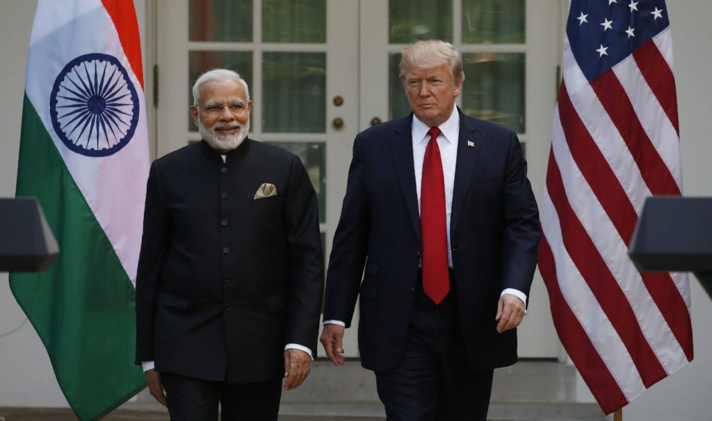 Modi and Trump Walking in the Isle with each side have their respective country's flag, India and USA.